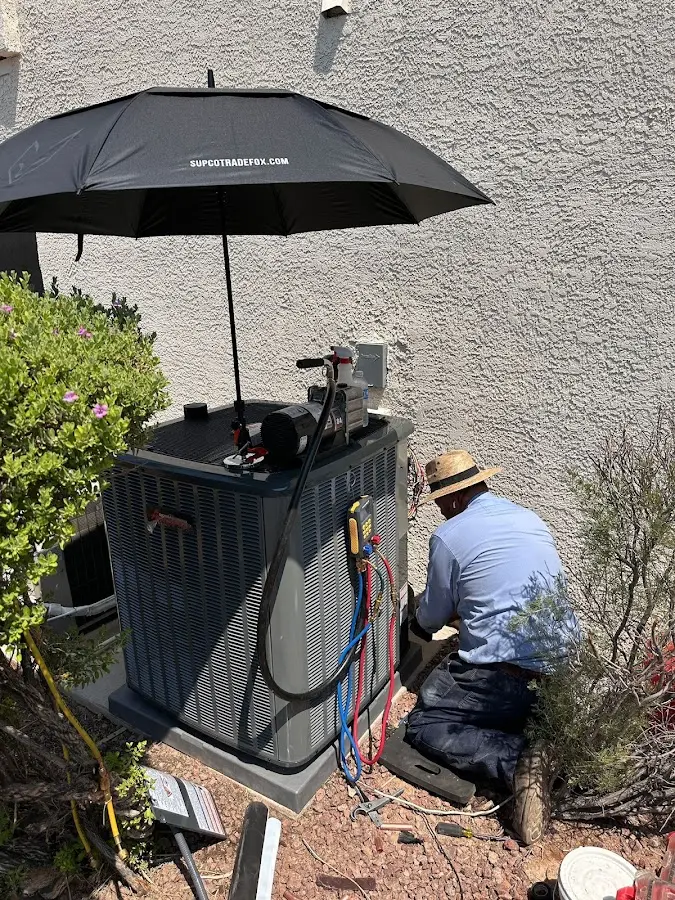 HVAC technician performing outdoor AC maintenance in DeSoto